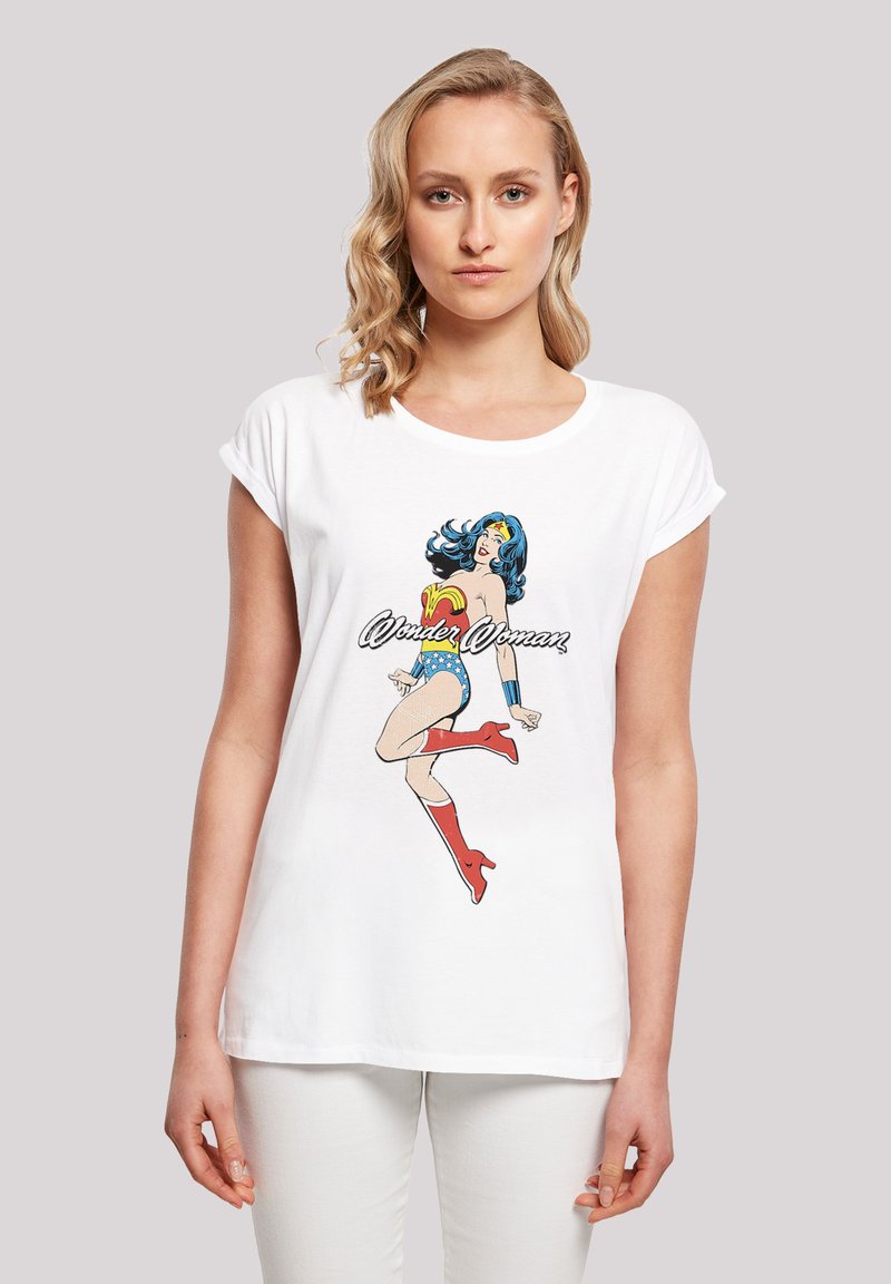 White cotton t-shirt featuring a color graphic of Wonder Woman, with short rolled sleeves and a loose fit. Text "Wonder Woman" beneath the image.