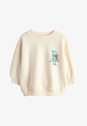 Kremowa bluza z prążkowanym kołnierzem, mankietami i dołem, z małą zieloną kreskówkową bubble tea z ramionami i nogami na piersi.