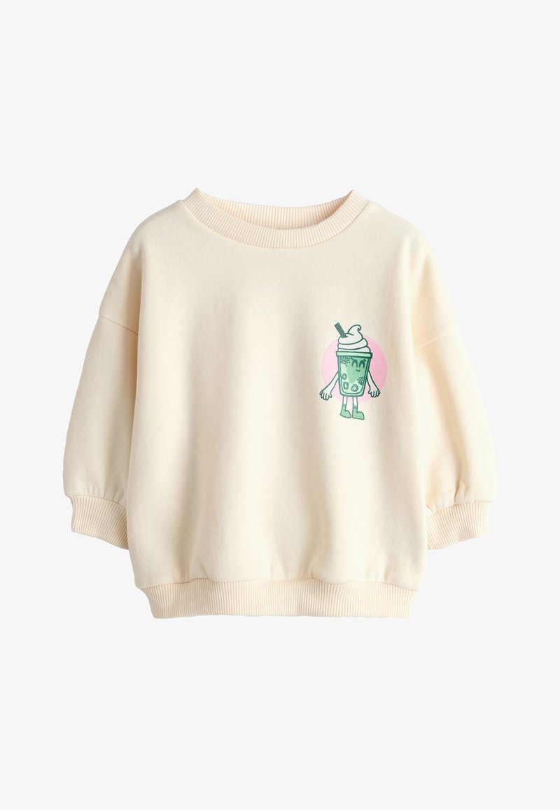 Sweat-shirt de couleur crème avec col, poignets et bas en côte, présentant un petit bubble tea vert de dessin animé avec bras et jambes sur la poitrine.