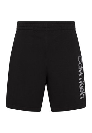Short noir avec taille élastique et logo vertical blanc "Calvin Klein" imprimé sur le devant de la jambe droite.