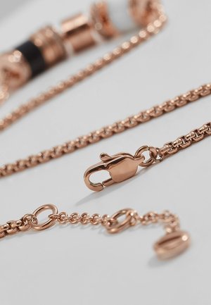 Collana con catena in oro rosa, chiusura a moschettone e catena di estensione regolabile su sfondo grigio chiaro.
