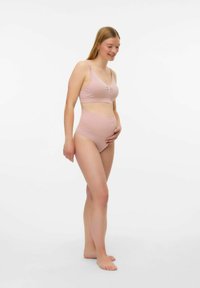 Soutien-gorge de maternité et culotte taille haute en doux tissu rose clair avec une texture côtelée et des détails subtils sur le soutien-gorge.