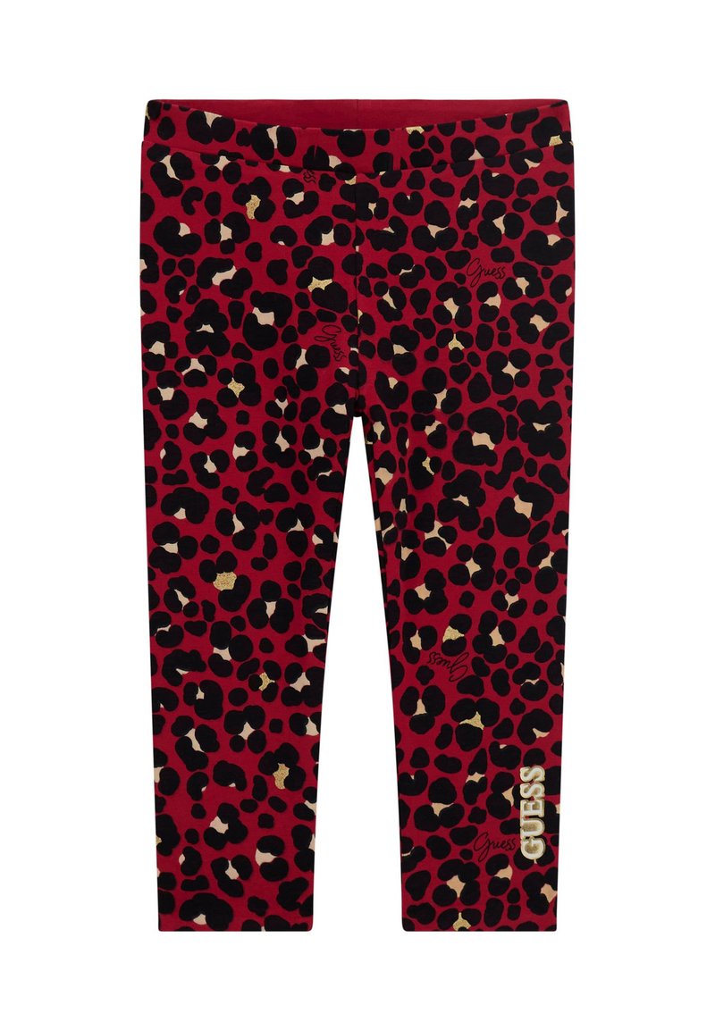 Red leggings featuring a black and gold leopard print design. "Guess" logo printed in white on the lower right leg. Smooth, stretchy material.