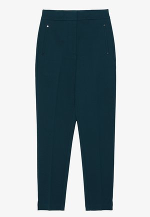 Pantaloni turchesi con un design aderente, due tasche frontali e una texture liscia. Presentano cuciture minime e piccoli accenti in hardware argentato.