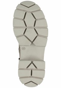 Suela de zapato de goma en un beige claro con un patrón de relieve triangular y hexagonal, que incluye una indicación de tamaño (37) y una superficie texturizada para mayor agarre.
