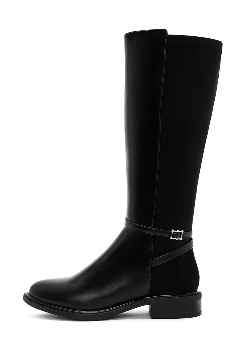 Bota negra hasta la rodilla con un acabado de cuero liso, punta redondeada y un bajo tacón cuadrado. Presenta una correa decorativa con una hebilla de tono plateado.