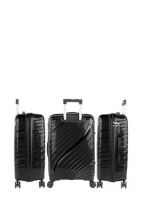 Maleta negra de carcasa dura con diseño texturizado, asa telescópica, cuatro ruedas y cierre de cremallera. Presenta un patrón ondulado en el frontal.