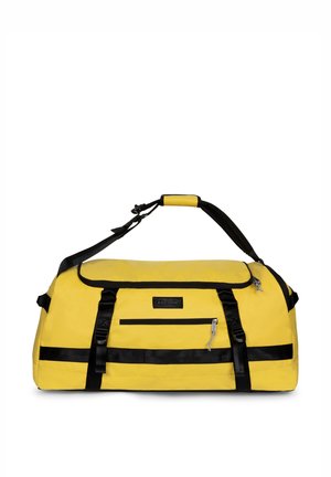 Bolsa de lona amarilla con correas negras, un bolsillo frontal con cremallera y una correa de hombro ajustable con agarre acolchado.