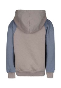 Huppari, jossa on vaaleanbeige runko ja siniset hihat, joustavat hihansuut ja helma sekä pehmeä pinta. Takakuvassa näkyy saumaton muotoilu.