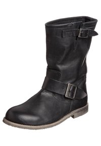 Bottine en cuir noir avec un bout rond, détail de boucle sur le côté et un talon bas. La surface texturée présente une finition légèrement vieilli.