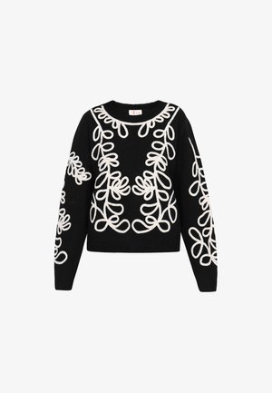 Mustern mustriga valge tikandiga must kampsun. Ümar kaelus, pikad varrukad ja lühike lõige koos ribatud servade detailiga.