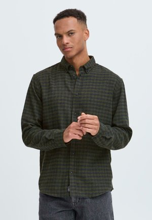 Checked button-up shirt in dark green and navy with long sleeves and a collar, featuring a textured fabric and black buttons.