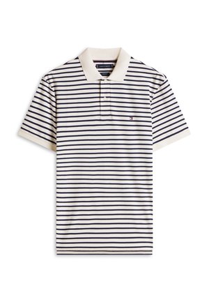 Puuvillainen poolopaita, kerma ja tummansiniraidallinen, jossa klassinen kaulus ja kolmen napin nappilista. Pieni logo vasemmassa rinnassa.