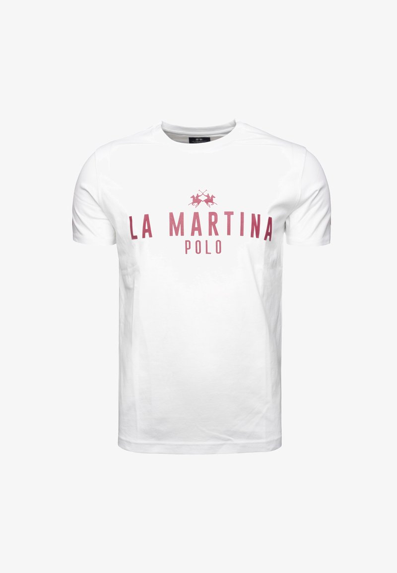 Valkoinen puuvillapaita, jossa on punainen "LA MARTINA POLO" -logo ja kaksi ristiin olevia polo-mailoja tekstin alla. Yksinkertainen pyöreä kaula-aukko.