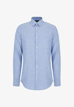 Jasnoniebieska koszula z długim rękawem wykonana z teksturowanej tkaniny. Posiada kołnierz zapinany na guziki, przód z guzikami oraz zaokrąglony dół.