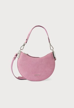 Pink suede handbag with a crescent shape, featuring a detachable strap and silver hardware accents. Smooth texture, minimalist design.