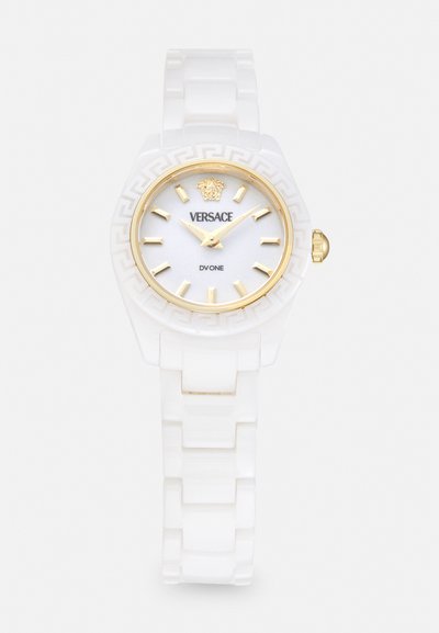 Witte siliconen horloge met een ronde wijzerplaat, gouden uurmarkers en een witte gestructureerde band. Heeft een gouden kroon en een gegraveerd logo.