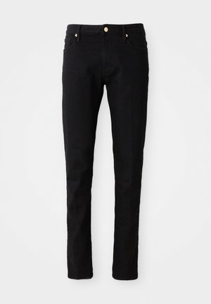 Schwarze Denim-Hose mit schmaler Passform, Fünf-Taschen-Design und goldfarbener Knopfverschluss. Glatte Textur mit minimaler sichtbarer Abnutzung.