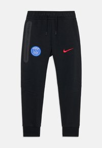 Jogging noirs sportifs avec le logo du Paris Saint-Germain sur la cuisse gauche et le swoosh rouge de Nike sur la cuisse droite, avec une poche zippée et une taille à cordon.