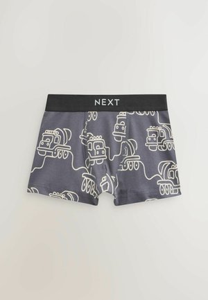 Boxers en coton gris avec une ceinture élastique noire portant le texte "NEXT." Le design comprend des illustrations de camions blancs sur l'ensemble.