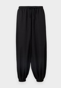 Mustad, vabalt istuvad püksid elastse vöökohaga ja paelaga. Kitsenevad sääred pahkluude juures. Pehme kangas ja sile tekstuur.