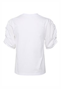 T-shirt en coton blanc à manches courtes bouffantes, avec un texture froncée aux épaules et un col rond classique. Vue de dos affichée.