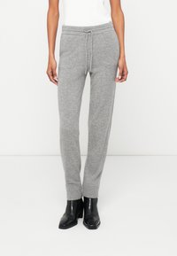 Grijze trainingsbroek met een elastische tailleband en een trekkoord, met een taps toelopende pijp en ribgebreide boorden, gemaakt van zachte, gestructureerde stof.