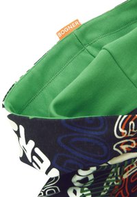 Bolsa de tela multicolor con un exterior estampado en azul, verde y blanco; cuenta con un interior suave en verde y una etiqueta de marca naranja.