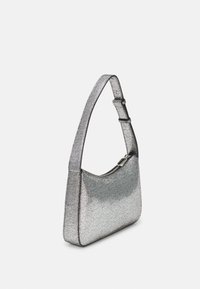 Metallic silver shoulder bag with a smooth texture, curved shape, and adjustable strap. Features a zippered top and minimalistic design.