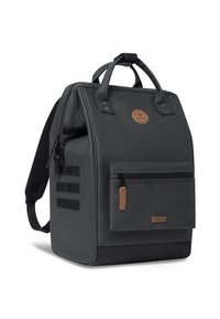 Sac à dos noir au design structuré, avec une poche zippée sur le devant, des accents en cuir et un tissu robuste, comprenant des sangles latérales pour l'attache.