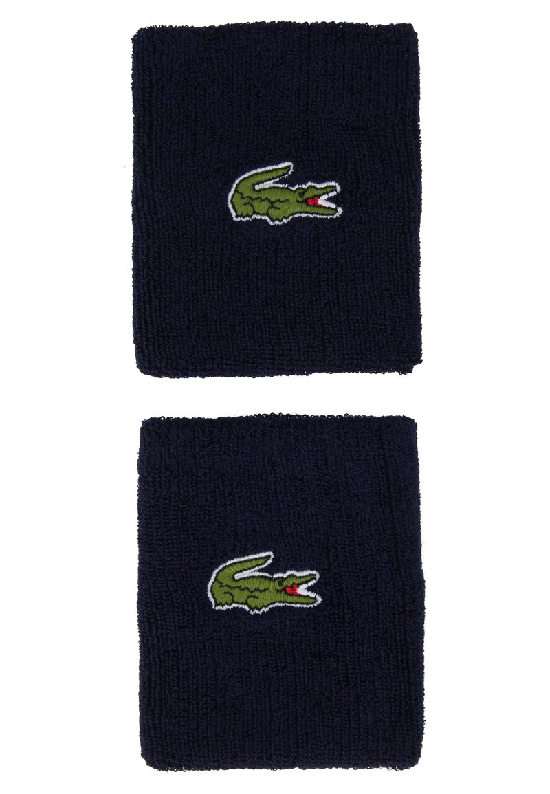 Pulseiras de pulso em tecido terry azul-marinho, com um logótipo de crocodilo verde bordado e detalhes em vermelho. Textura suave com formato retangular.