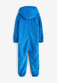 Combinaison bleu, pelucheuse, avec une capuche, présentant un motif texturé de cœurs en relief, des poignets élastiques et une coupe décontractée.