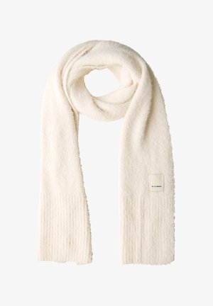 White, plush scarf featuring a ribbed texture, soft fabric, and a label patch; long, draped design suitable for various styles.