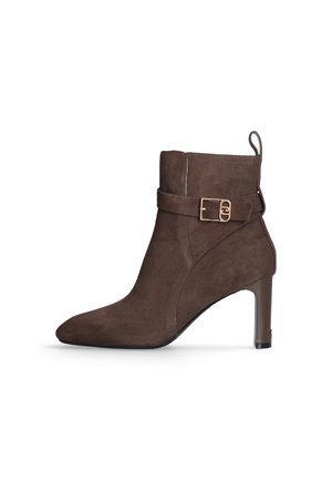 Brown suede ankle boot with a pointed toe, high heel, and a decorative strap featuring a gold buckle detail.