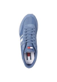 Zapatilla azul con material de lienzo y gamuza, con rayas blancas y logo en la lengüeta, puntera redonda y suela de goma texturizada.