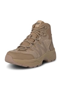 Tan high-top shoes featuring a mix of smooth and textured materials, breathable mesh panels, and a reinforced sole for traction.