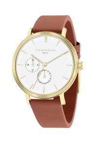 Gouden horloge met een witte wijzerplaat, twee subdials en een rozenkleurige siliconen band. Kenmerkt zich door minimalistische uurmarkeringen en een gestructureerde bezel.