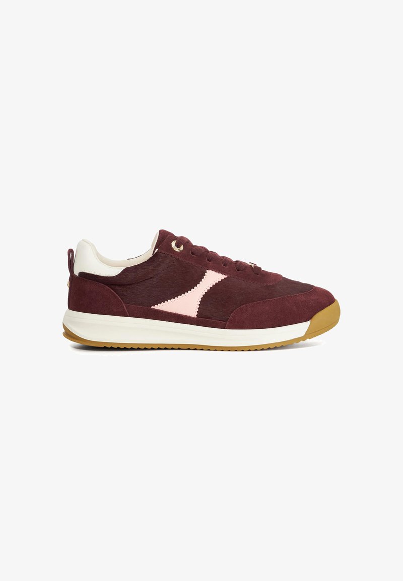 Maroon suede sneaker with a pink geometric accent, white heel, and gum rubber sole. Features metal eyelets and lace closure.