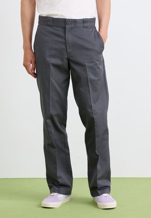 Gray trousers featuring a smooth texture, straight-leg design, two front pockets, and a single button closure at the waistband, worn with light sneakers.