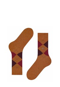 Brązowe skarpetki w wzór argyle w ciemnoczerwonym i musztardowym kolorze, z metalicznym akcentem w górnej części; dzianina o gładkiej fakturze.