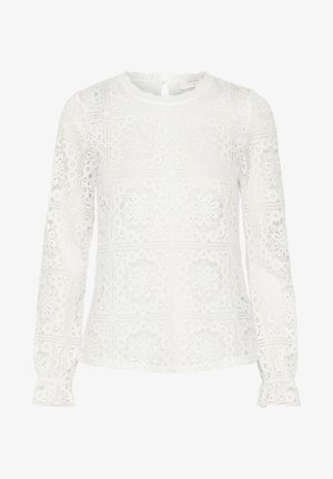 Vit långärmad blus i spets, med geometriska utskärningar, rund halsringning och volangärmar. Nyckelhål bak.