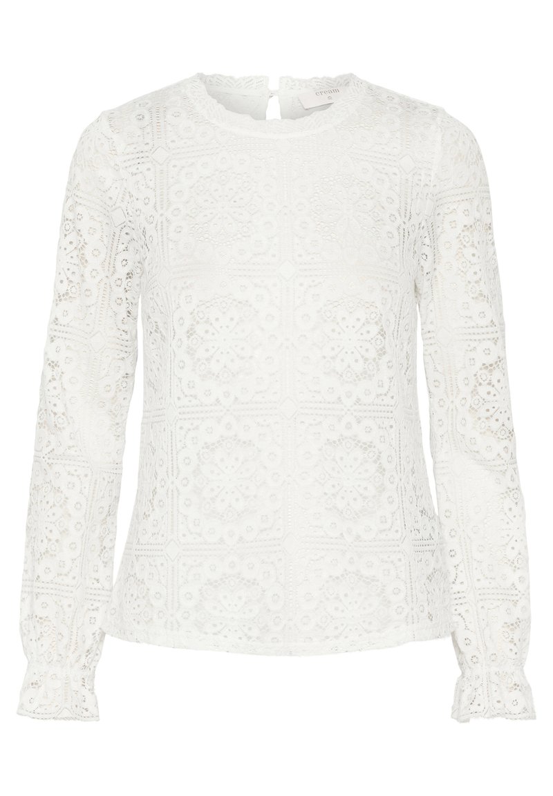 Weiße Langarmbluse aus Spitzenstoff mit geometrischem Blumenmuster, einem geschwungenen Ausschnitt und Knopfverschluss am Rücken.