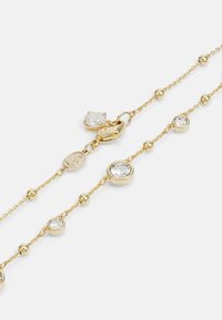 Golden chain bracelet featuring clear round and oval crystals, interspersed with metal beads, and a secure lobster clasp closure.