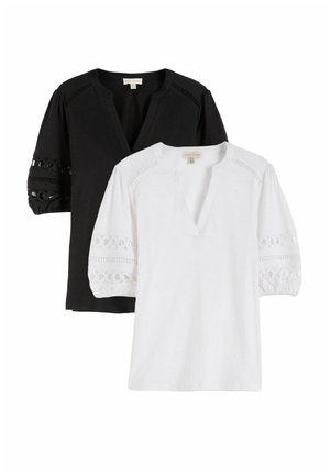 Two women's blouses with three-quarter puff sleeves and lace cutout details, one black and one white, both with V-necklines.