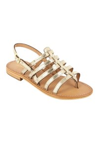 Gouden metallic strappy sandalen met een platte zool, open teenontwerp en een enkelbandje. Heeft een textuur met een metallic afwerking en een lichtbruine binnenzool.