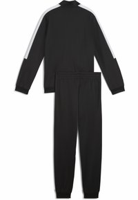Survêtement noir avec une veste zippée et un pantalon à taille élastique. La veste présente des bandes blanches en accent sur les manches. Tissu lisse et léger.
