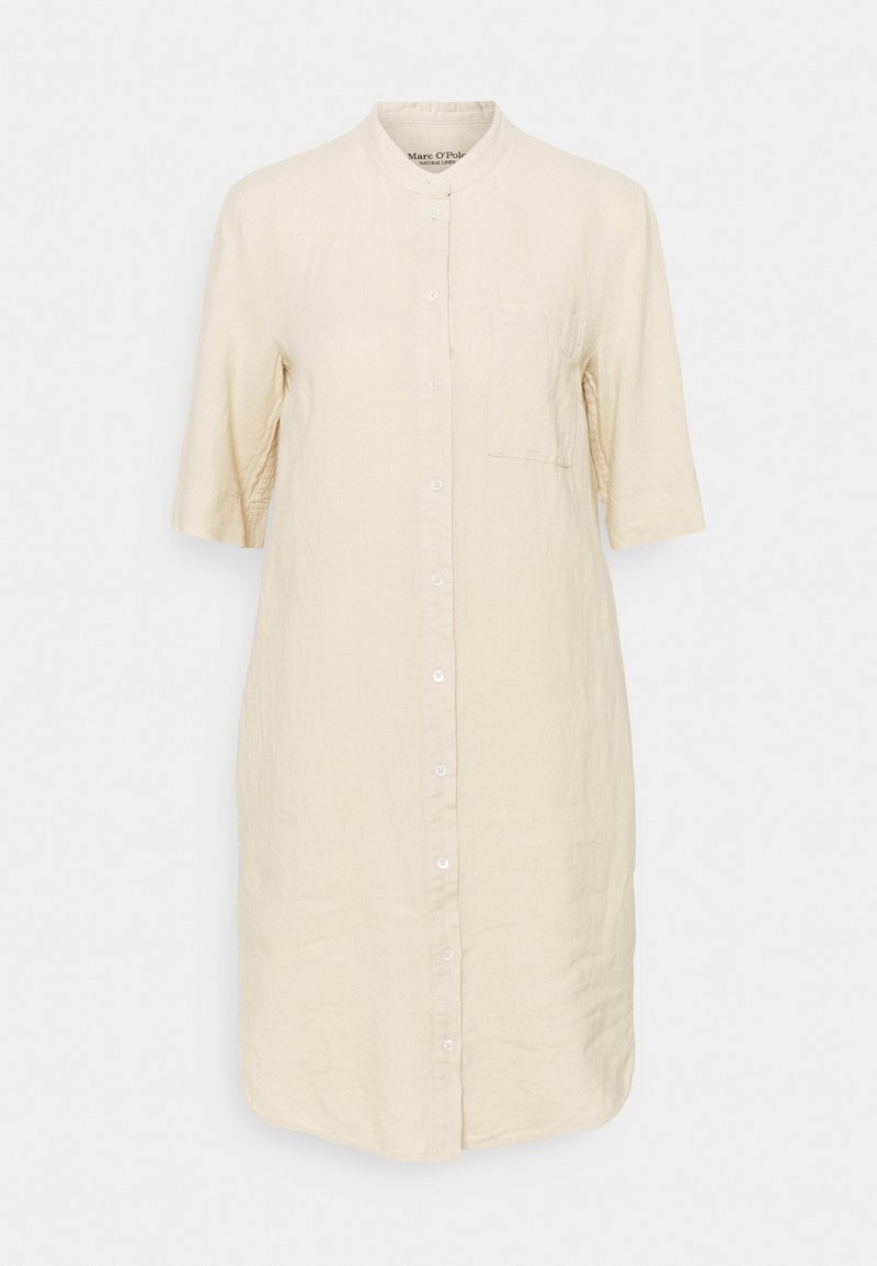 Beige linnen overhemdjurk tot op de knie met korte mouwen, mandarijnkraag, knopen aan de voorkant en een borstzak.