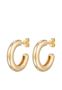 Goldfarbene Creolen mit einem geschwungenen Design, glatter Oberfläche und Steckverschluss. Auffällig durch ihr glänzendes Finish und ihre minimalistische Form.