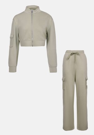 Cropped zip-up jacket and elastic waistband cargo pants in light olive green. Features side pockets on jacket and cargo-style pockets on pants.