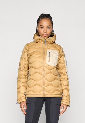 Tan puffer jacket with a high collar, quilted texture, blue zippers, and two zippered pockets. One pocket features a contrasting light color.
